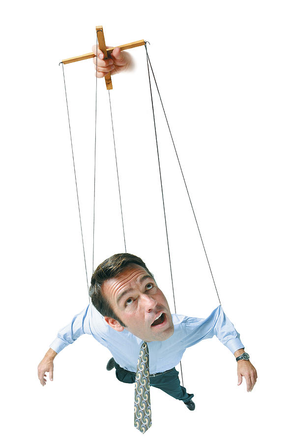Conceptual Caricature Of Businessman In Shirt Tie Hangs In Air By Strings As A Marionette Puppet Photograph by Photodisc