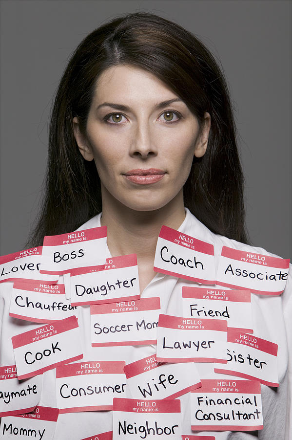 Conceptual Portrait Of An Adult Brunette Woman Who Is Covered With Multiple Labels And Name Tags Photograph by Photodisc