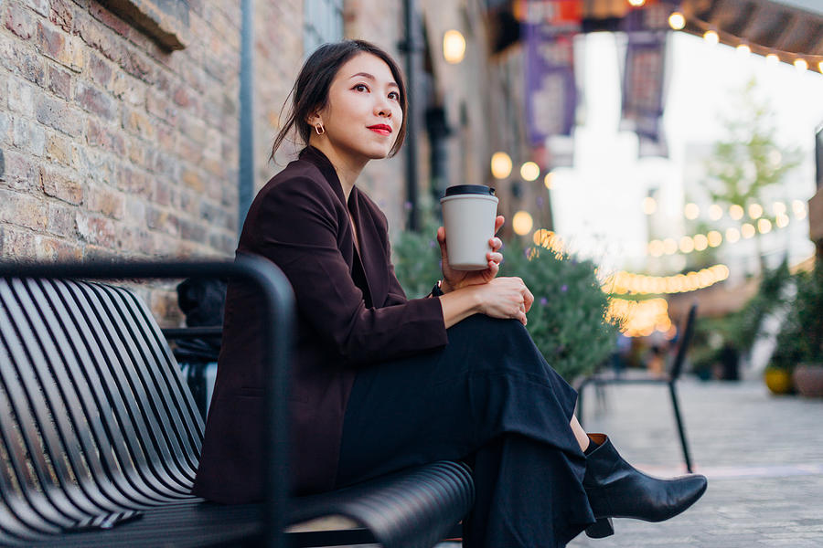 Confident Young Woman Drinking Coffee, Sitting At A Sidewalk Cafe Photograph by Oscar Wong