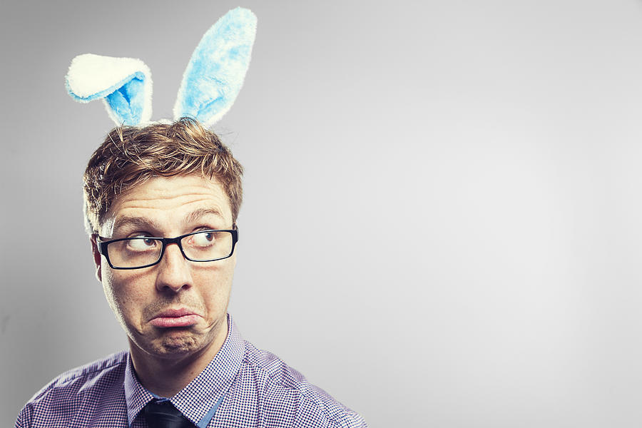 Confused Easter nerd with rabbit ears in a photography studio Photograph by Benstevens