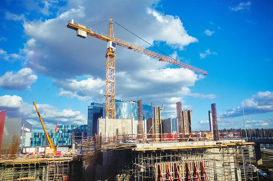 Construction site crane at blue sky background Photograph by Sergei Dubrovskii