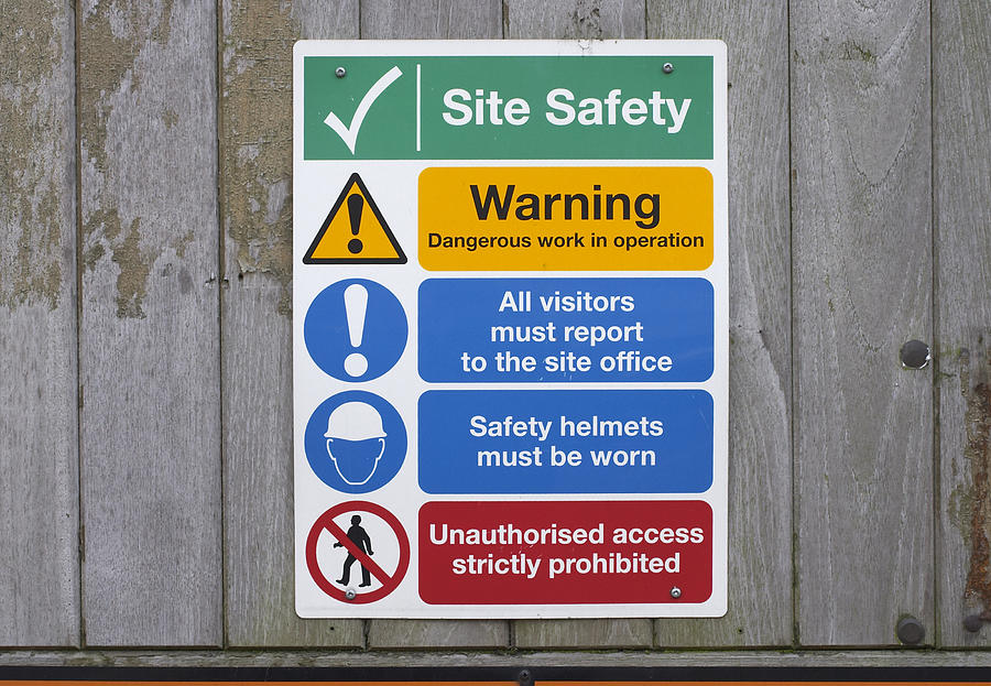 Construction site safety notices on wooden fence Photograph by Whiteway