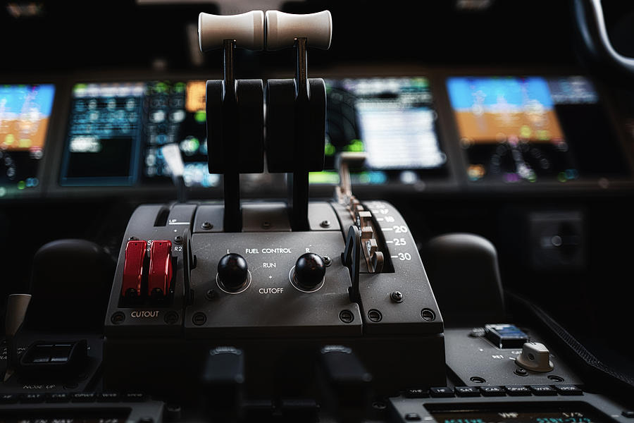 Controls and dashboards in the cockpit of an aircraft Photograph by Jun Xu