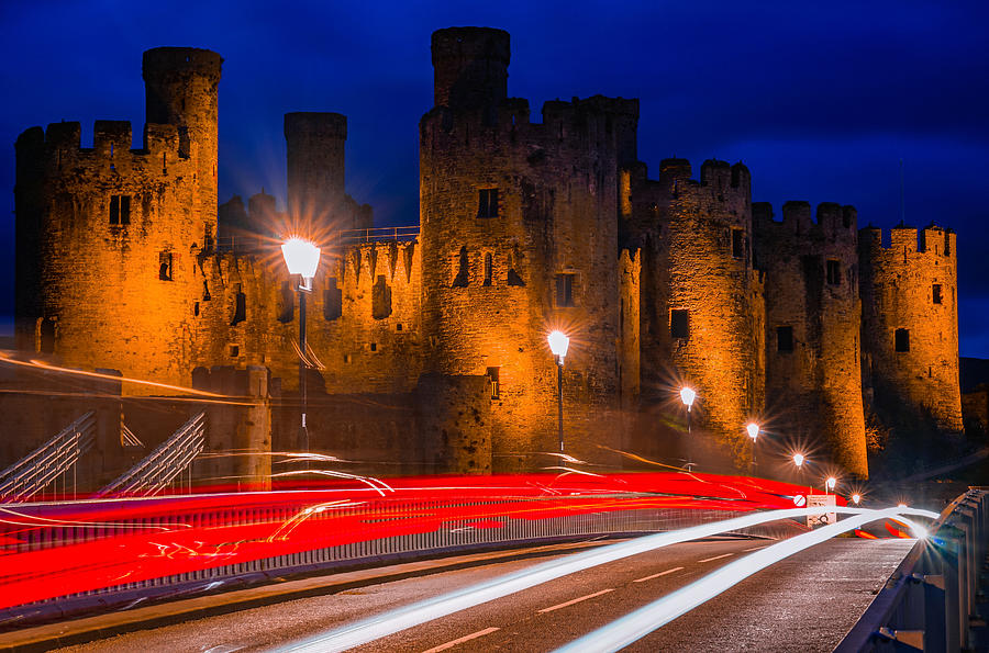 Conwy Castle In Wales Seen At Night With Incoming Traffic. Photograph