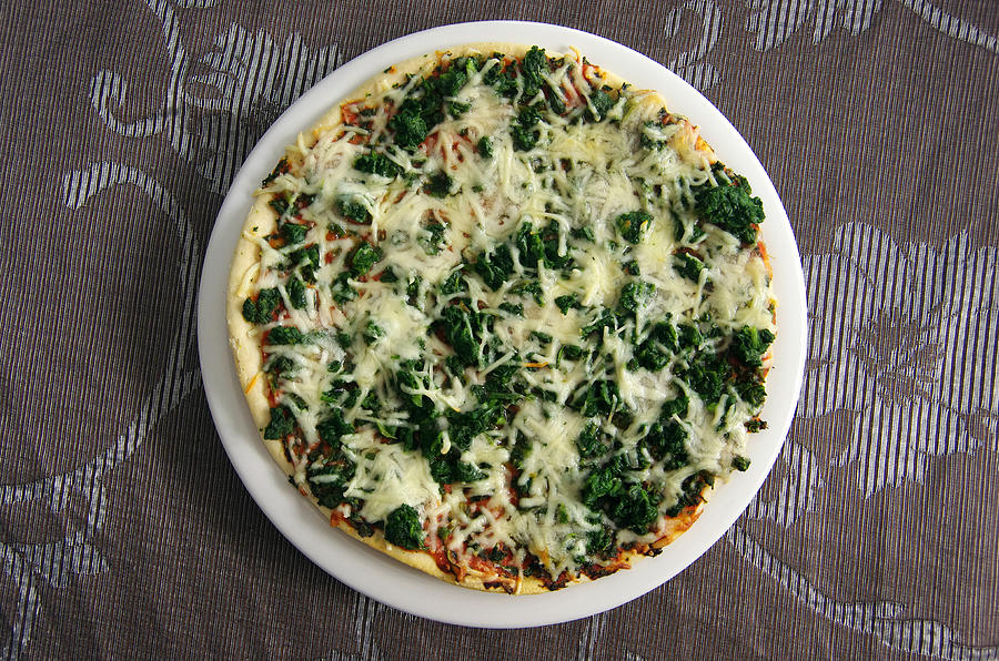 Cooked spinach and cheese frozen pizza Photograph by Simon McGill