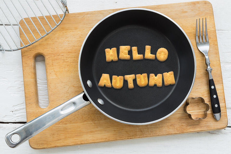 Cookie biscuits word HELLO AUTUMN in frying pan Photograph by Vinnstock
