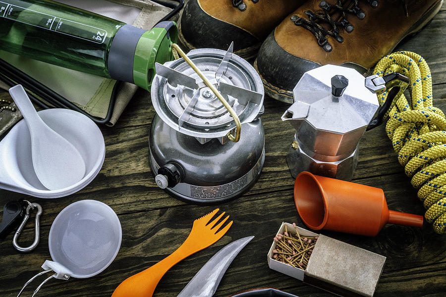 Cooking set . Travel equipment and accessories for mountain hiking trip on wood floor Photograph by Apomares