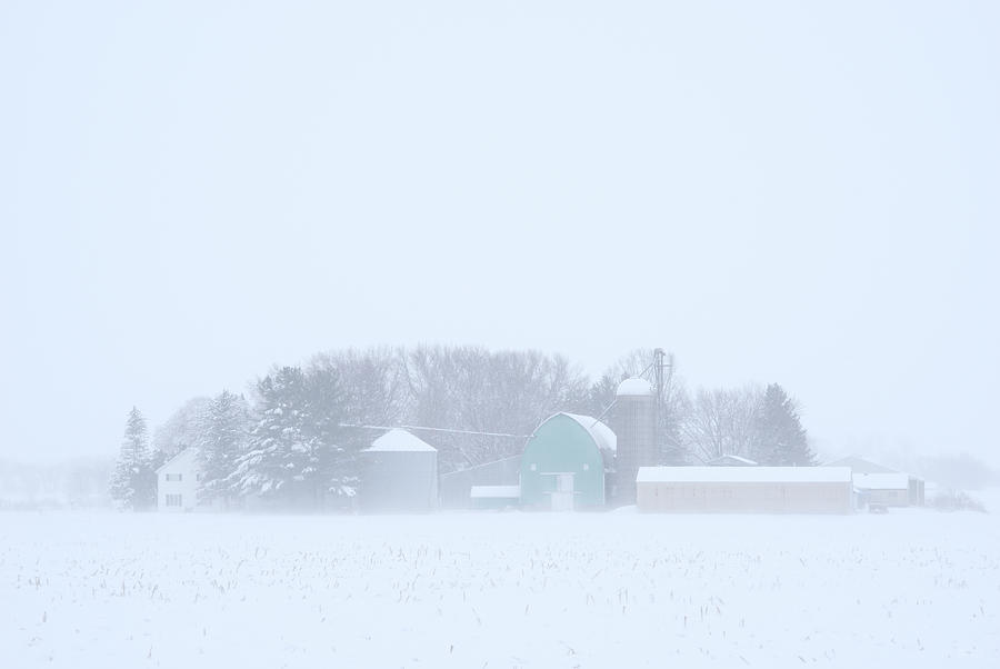 Cool Pastels - pastel colored farm buildings in a Wisconsin snowstorm Photograph by Peter Herman