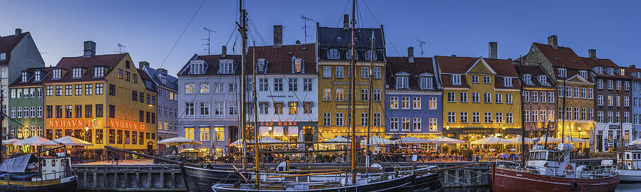 Copenhagen Nyhavn colorful bars and restaurants illuminated at dusk Denmark Photograph by fotoVoyager