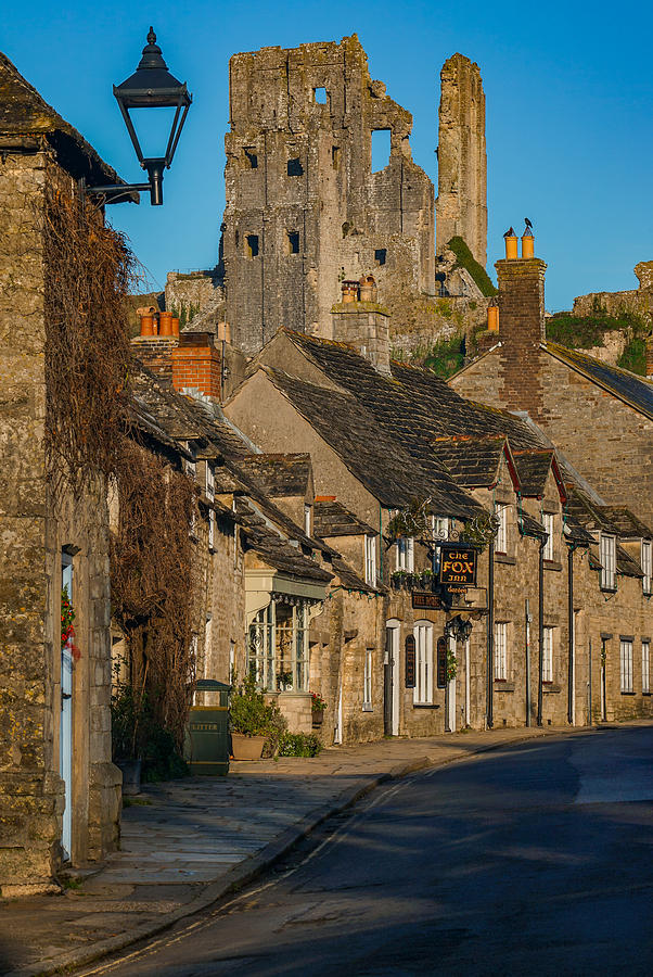 Corfe castle in England seen at sunrise. Photograph by George Afostovremea