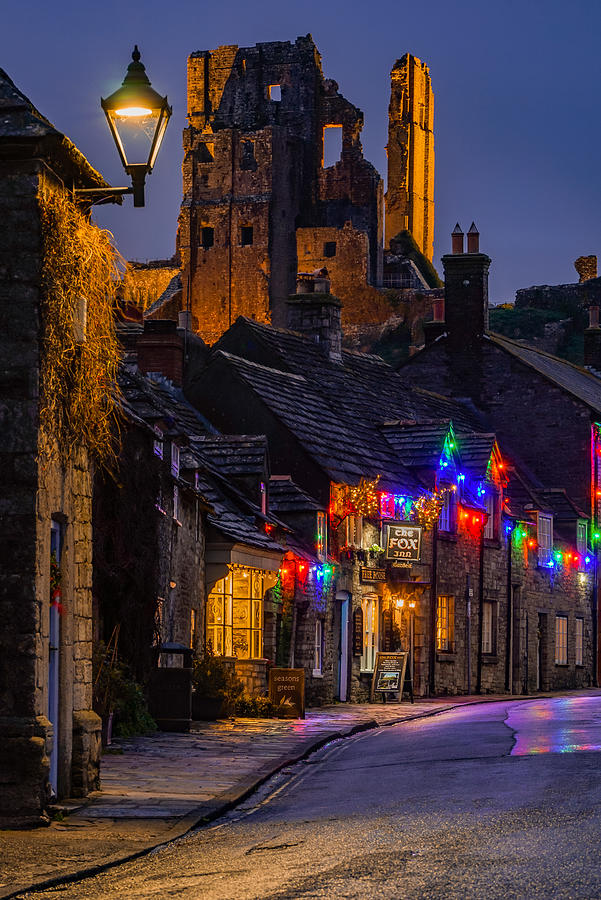 Corfe Castle In England Seen Lighten Up On A Rainy Lonely Night. Photograph