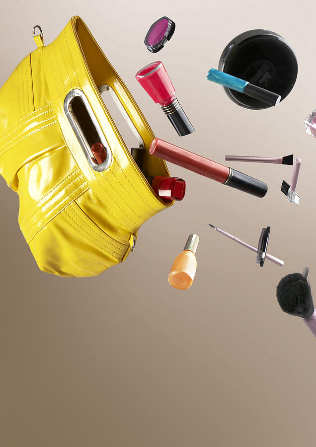 Cosmetics Falling Out Of A Hand Bag Photograph by Rebecca Van Ommen