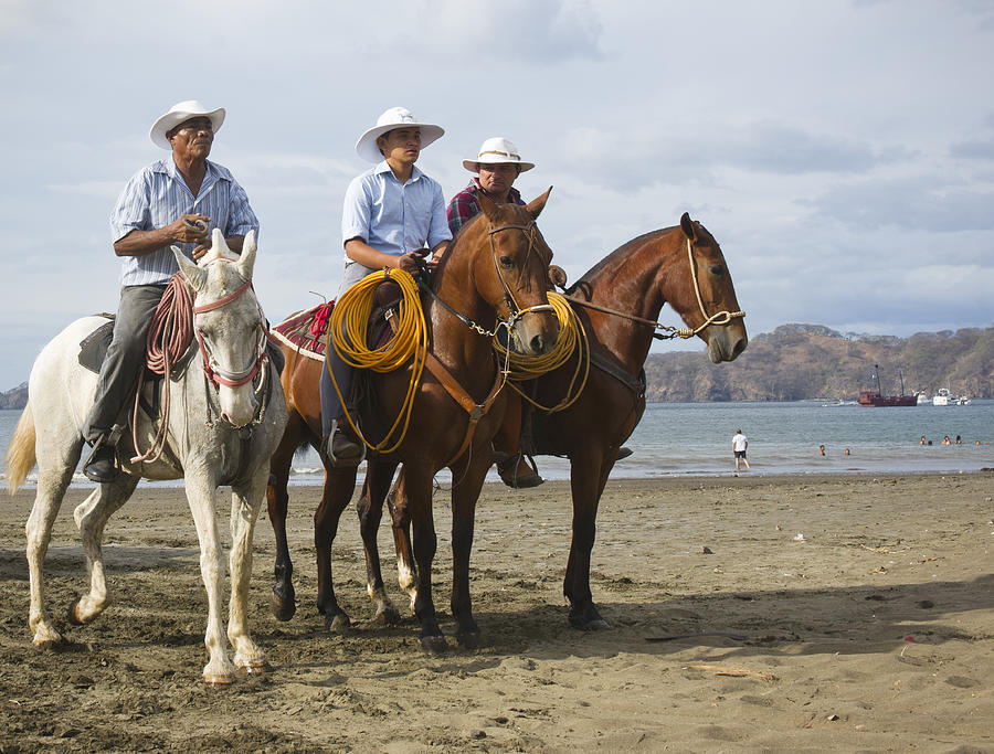 Costa Rican cowboys on the beach in Playas del Coco Photograph by Fertnig