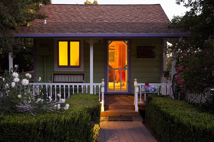 Cottage with a Woman Inside at Dusk. Photograph by Frank Gaglione