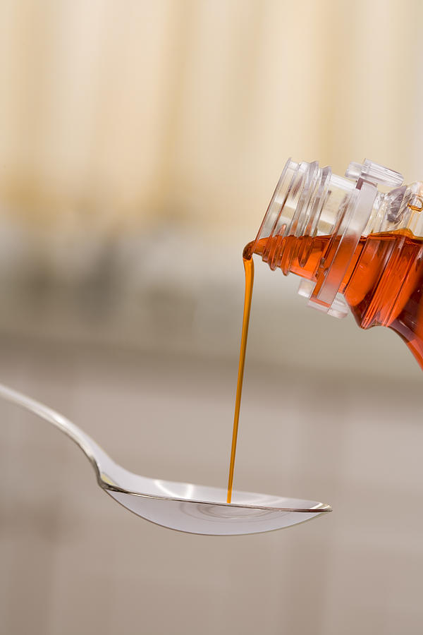Cough syrup and spoon Photograph by Comstock Images