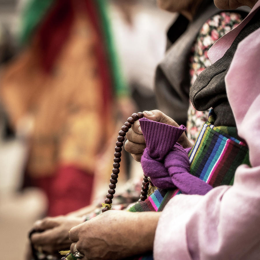 Counting beads on a mala Photograph by Murray Rudd