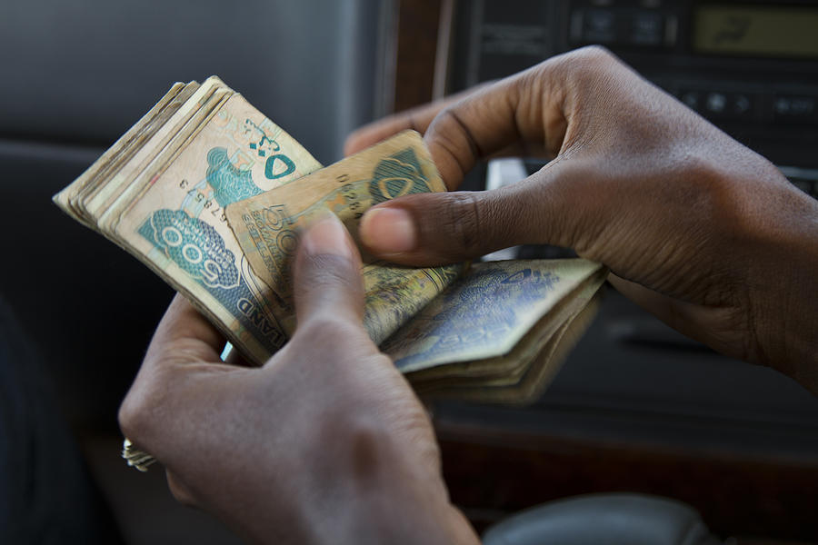 Counting the Somaliland shilling Photograph by Aldo Pavan