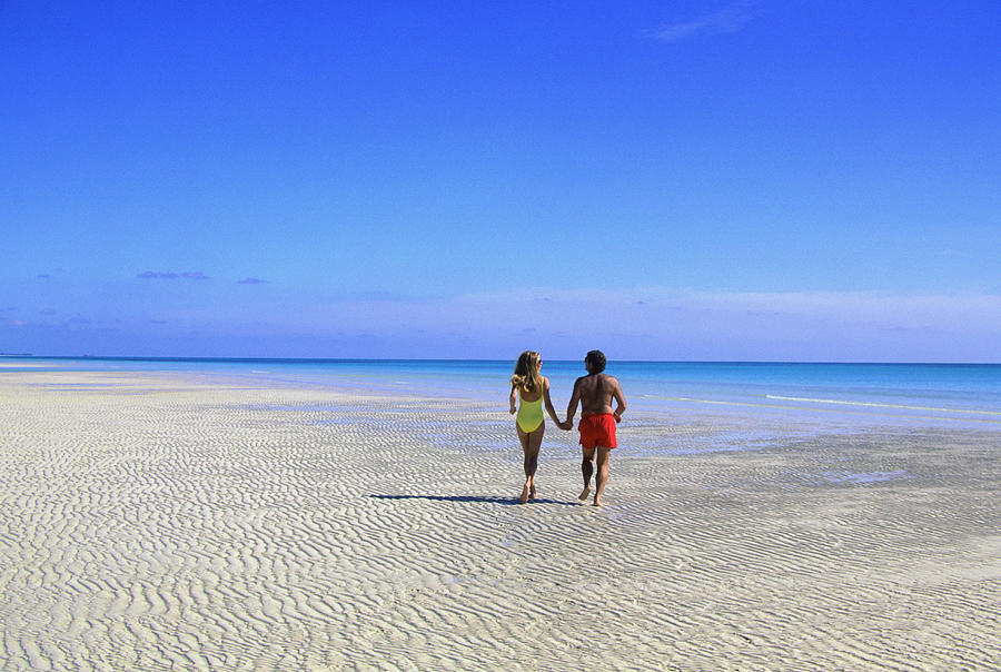 Couple alone on beach at Lucayan National Park, Grand Bahama Island, Bahamas Photograph by Medioimages/Photodisc