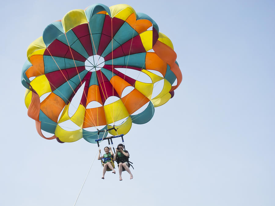 Couple are parasailing in sky. Photograph by Lawren Couple are parasailing in sky. Photograph by Lawren