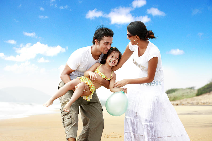 Couple at a beachside with their daughter Photograph by Visage