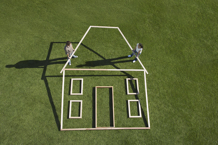 Couple building house outline Photograph by Martin Barraud