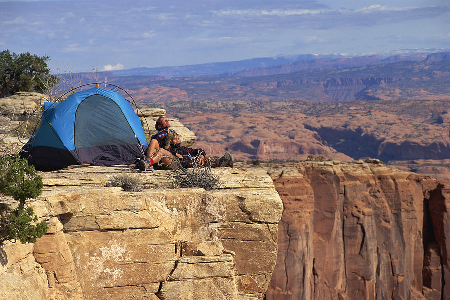 Couple camping by canyon landscape Photograph by Comstock Images