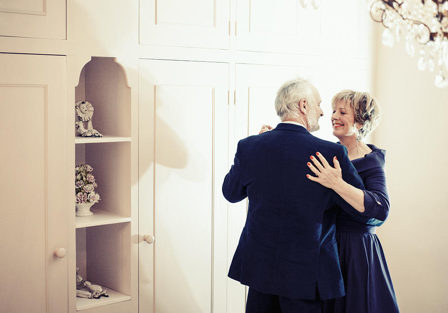 Couple dancing in bedroom Photograph by Redheadpictures
