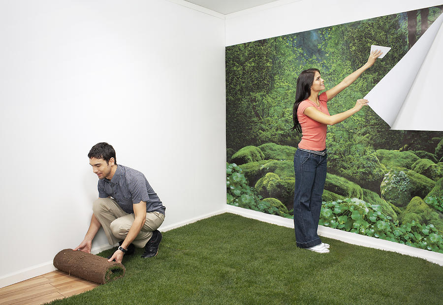 Couple decorating new home with nature themes Photograph by Andy Ryan