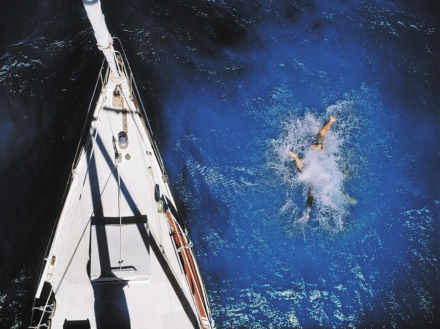 Couple Diving from Yacht Photograph by David Trood