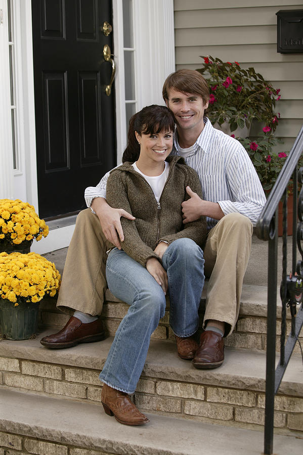 Couple embracing on steps Photograph by Comstock Images
