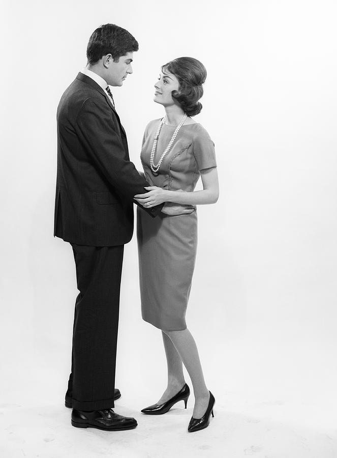 Couple embracing, studio shot Photograph by George Marks