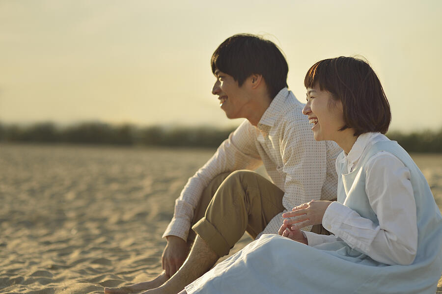Couple enjoying day out at the beach Photograph by Yagi Studio