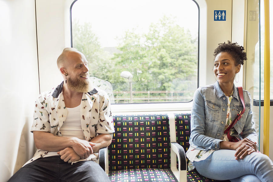 Couple flirting on train Photograph by Flashpop
