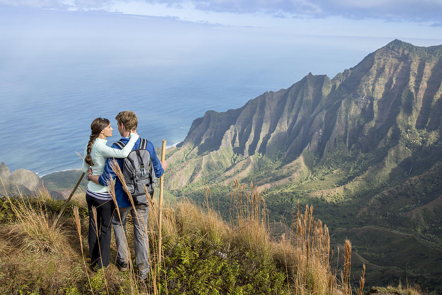 Couple hiking while on vacation in Hawaii Photograph by FatCamera