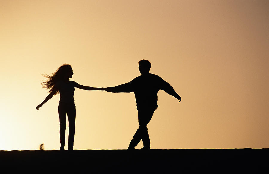 Couple holding hands, silhouette Photograph by David De Lossy