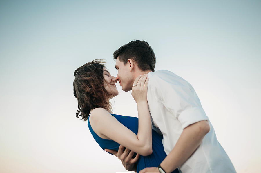 Couple kissing near the sea Photograph by Igor Ustynskyy
