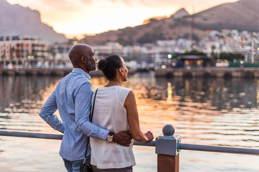 Couple looking at sunset at Cape Town waterfront Photograph by Alistair Berg