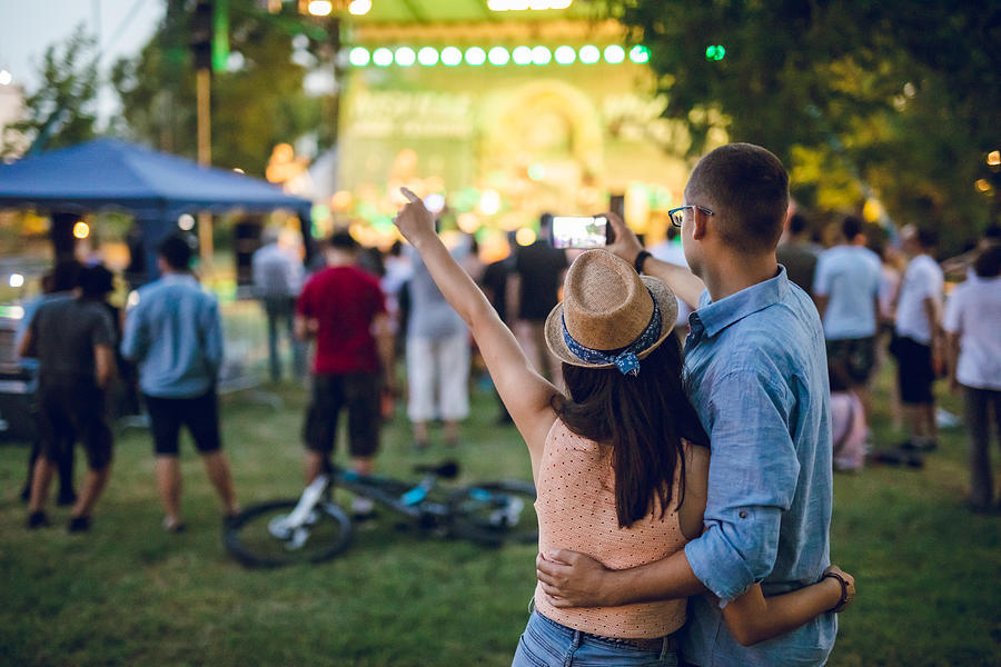 Couple making selfie on a music festival Photograph by Urbazon