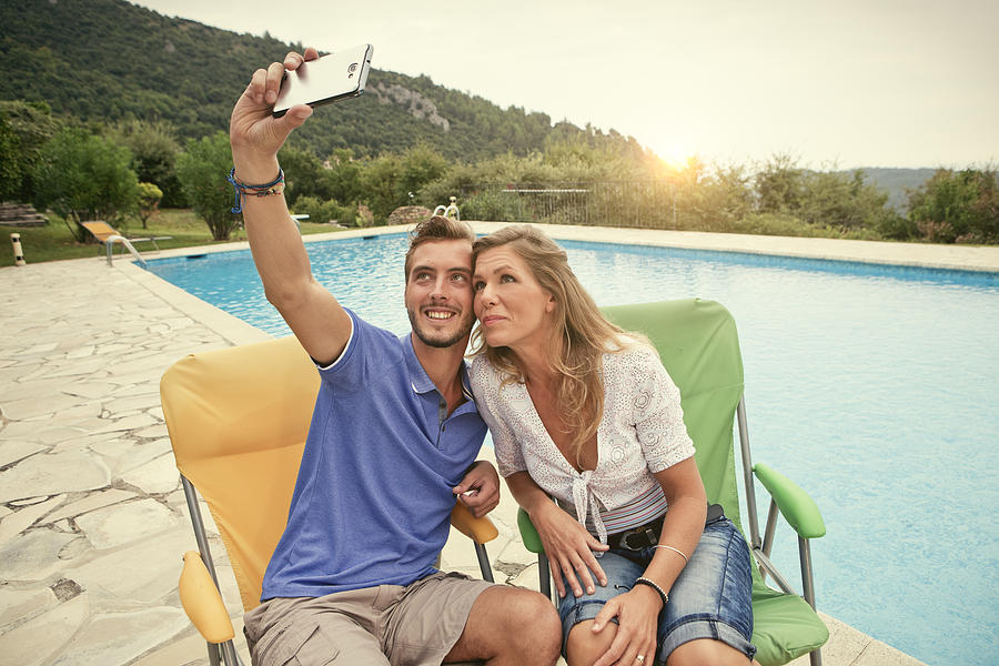 Couple on Holiday taking a selfie in france Photograph by Marcus Clackson