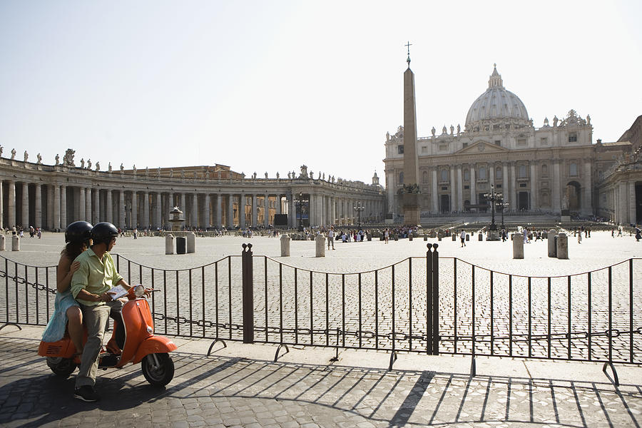 Couple on motor scooter , Saint Peters Cathedral , Vatican City , Rome , Italy Photograph by Jupiterimages