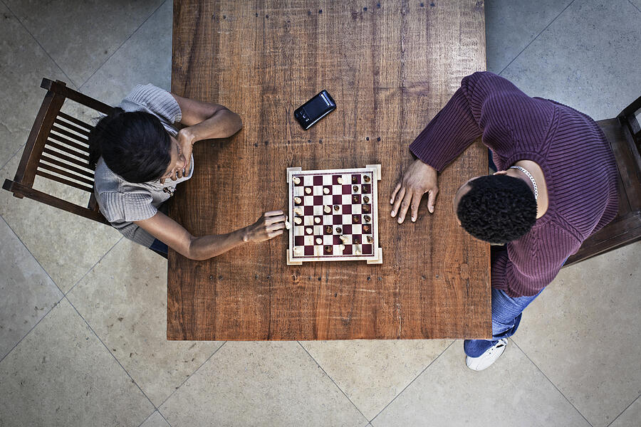Couple playing chess together Photograph by Hill Street Studios