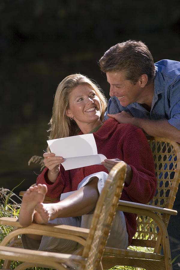 Couple reading letter Photograph by Comstock Images
