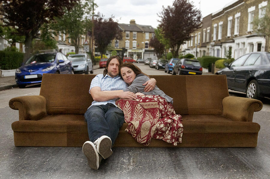 Couple  Relaxing On Settee In The Street Photograph by John Rensten