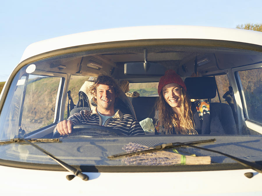 Couple siting in camper van. Photograph by Dougal Waters