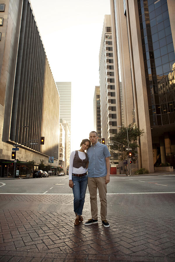 Couple standing on city street Photograph by Kyle Monk