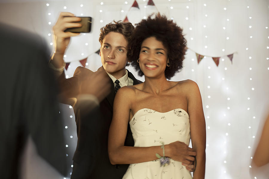 Couple taking a selfie at prom party Photograph by Orbon Alija