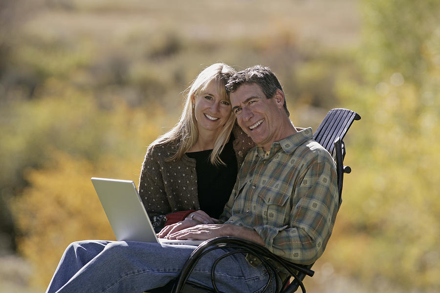Couple using laptop Photograph by Comstock Images