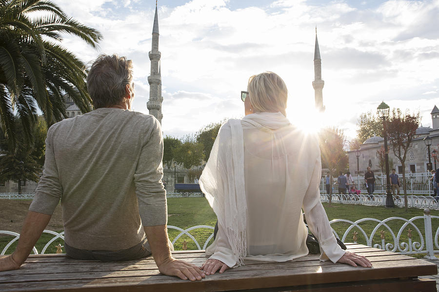 Couple watch sunrise over Blue Mosque, gardens Photograph by Ascent/PKS Media Inc.