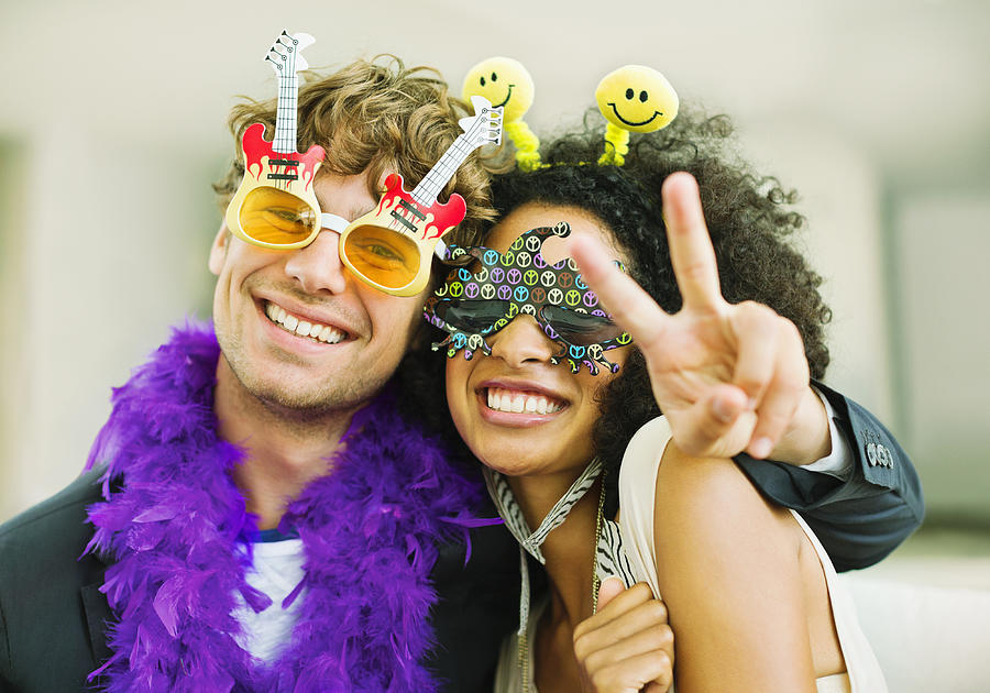 Couple wearing decorative glasses at party Photograph by Dan Dalton