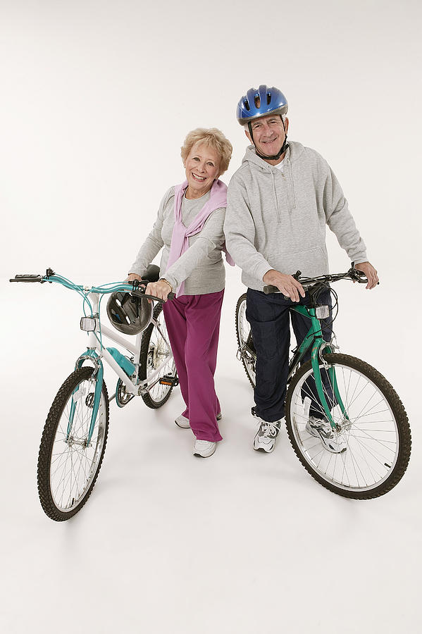 Couple with bikes Photograph by Comstock Images